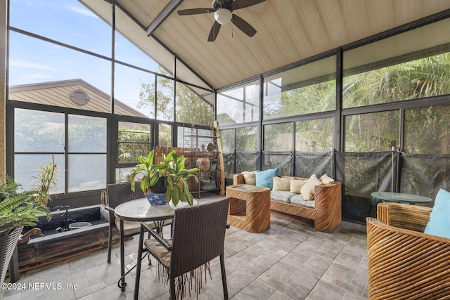 sunroom / solarium featuring lofted ceiling, ceiling fan, and wooden ceiling