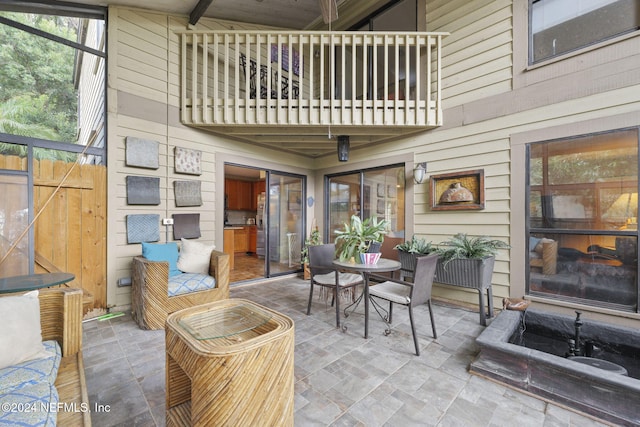 sunroom / solarium featuring a wealth of natural light and beamed ceiling