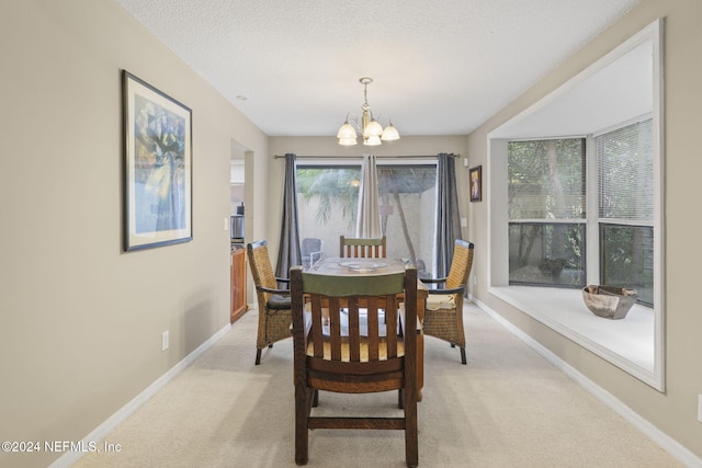 carpeted dining room featuring a textured ceiling and a notable chandelier