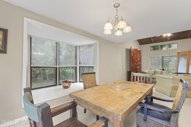 dining area with wood-type flooring, an inviting chandelier, and lofted ceiling