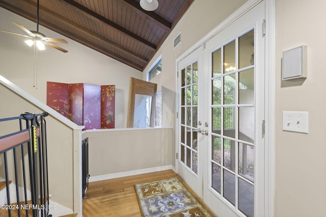 doorway with french doors, lofted ceiling with beams, wood ceiling, and wood-type flooring