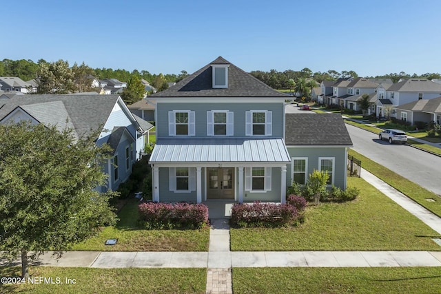 view of front of home with a porch and a front yard