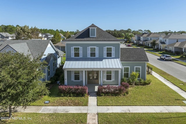51 Topiary Ave, Saint Augustine, FL 32092 - view of front of house with a residential view, a front yard, covered porch, and roof with shingles