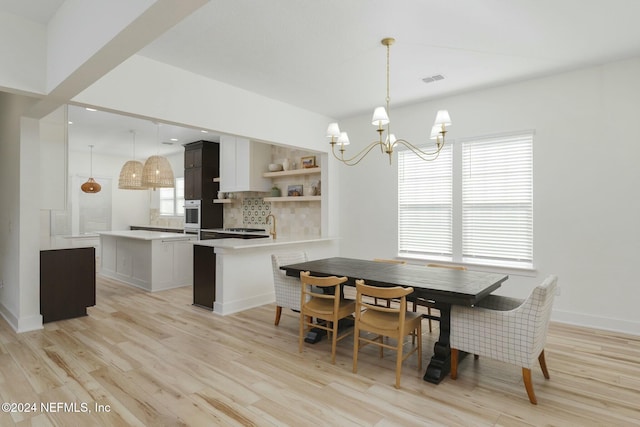 dining room featuring a chandelier and light hardwood / wood-style flooring