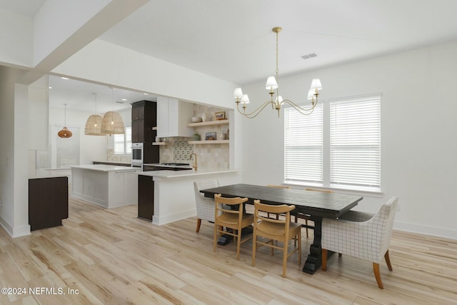 51 Topiary Ave, Saint Augustine, FL 32092 - dining space with a chandelier, light wood-type flooring, and baseboards