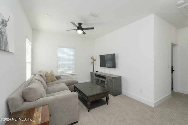 living room featuring light carpet and ceiling fan