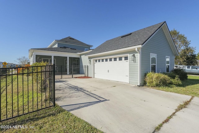 view of front of home with a front yard and a garage