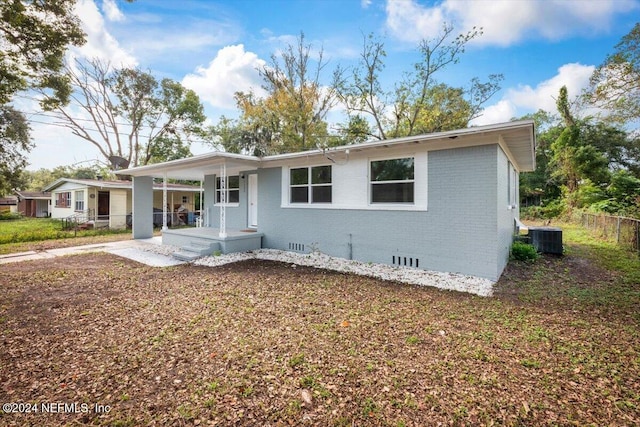 view of front of house with central AC unit and a patio area