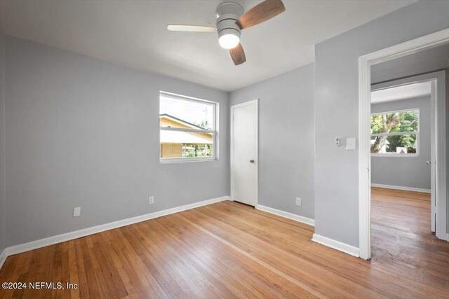 spare room featuring light wood-type flooring and ceiling fan