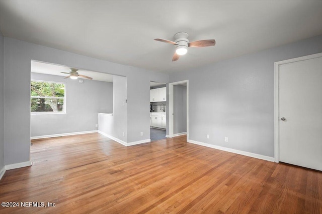 empty room featuring ceiling fan and light hardwood / wood-style flooring