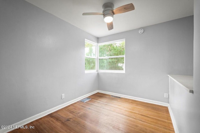 empty room with wood-type flooring and ceiling fan