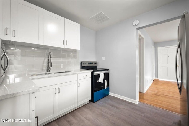 kitchen with white cabinets, sink, light hardwood / wood-style floors, and stainless steel appliances