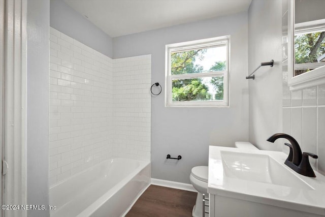 full bathroom featuring hardwood / wood-style floors, vanity, toilet, and tiled shower / bath