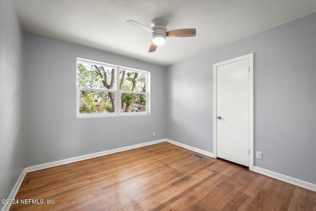 unfurnished room featuring hardwood / wood-style floors and ceiling fan