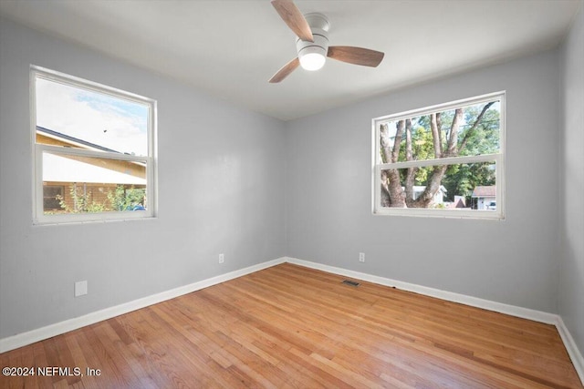 spare room featuring light hardwood / wood-style flooring and ceiling fan