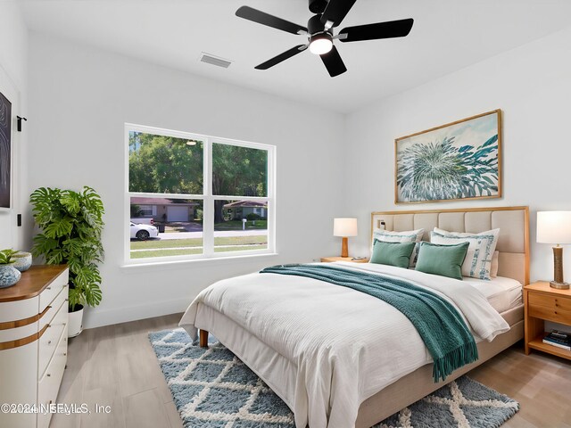 bedroom with light wood-type flooring and ceiling fan