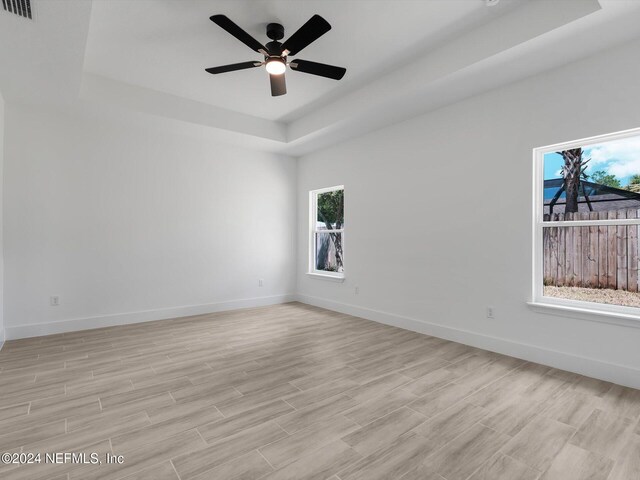 unfurnished room featuring a wealth of natural light and light wood-type flooring