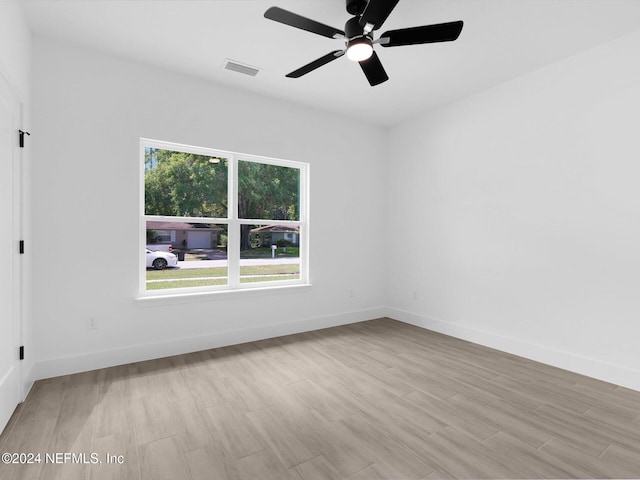 spare room with light hardwood / wood-style floors and ceiling fan