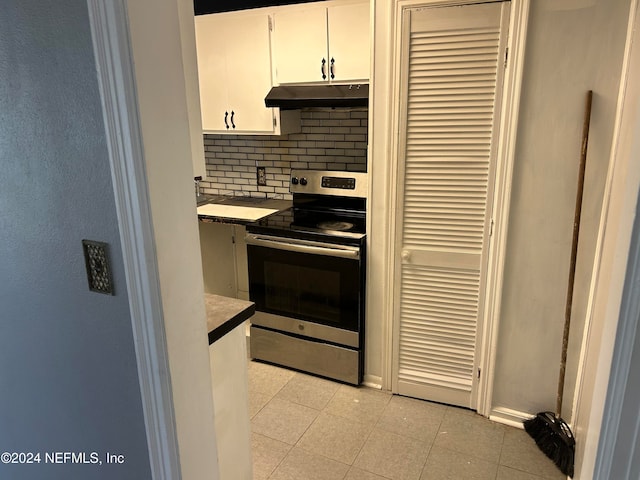 kitchen featuring white cabinetry, electric stove, and backsplash