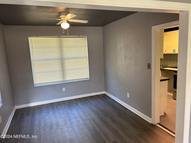 unfurnished room featuring dark hardwood / wood-style flooring and ceiling fan