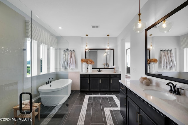 bathroom with shower with separate bathtub, vanity, and tile patterned flooring