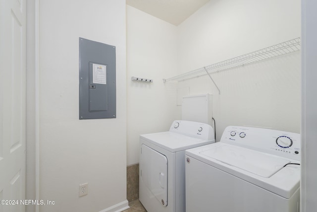 washroom with electric panel and washing machine and clothes dryer