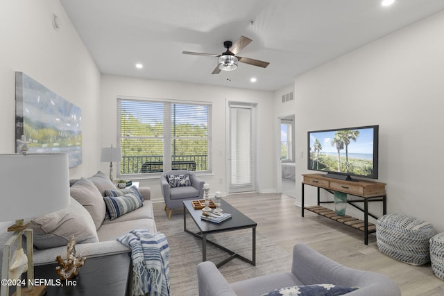 living room with ceiling fan, a healthy amount of sunlight, and light hardwood / wood-style flooring