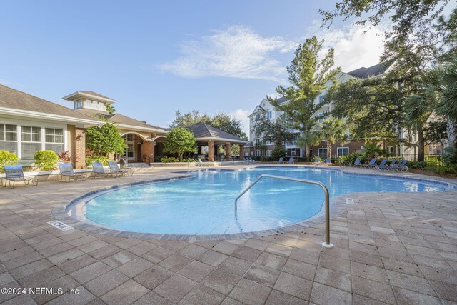 view of swimming pool with a patio and a gazebo