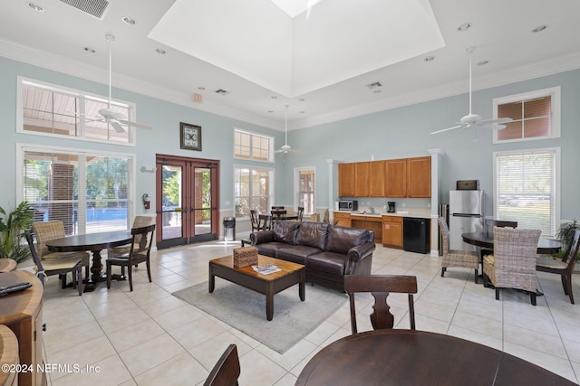 living room featuring french doors, a towering ceiling, ceiling fan, and light tile patterned floors