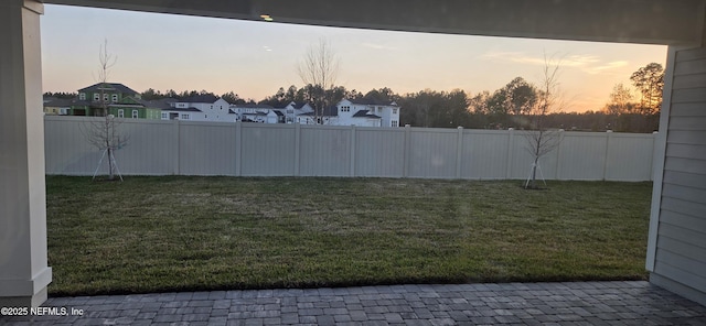 view of yard featuring a fenced backyard and a residential view