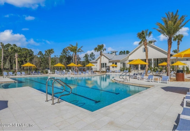 community pool featuring a patio and fence