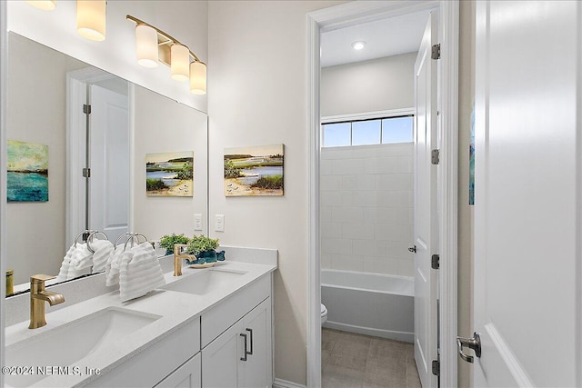 full bathroom featuring toilet, shower / bathing tub combination, and vanity