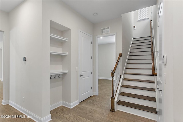 stairway with hardwood / wood-style flooring