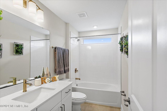 full bathroom with vanity, toilet, and tiled shower / bath combo