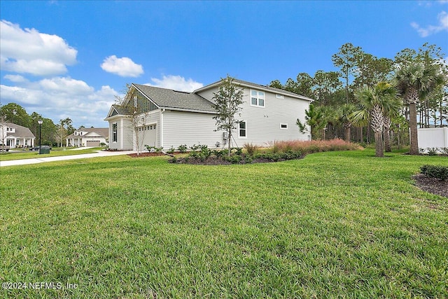 view of home's exterior with a lawn and a garage