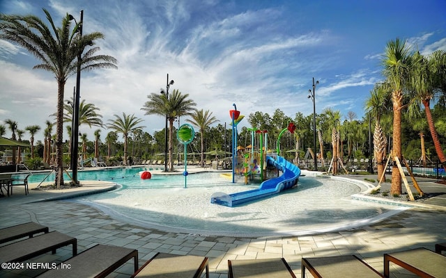 view of playground featuring a community pool