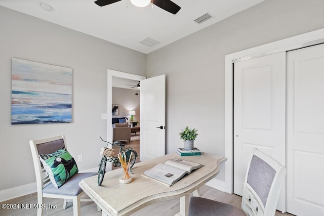 office space with light wood-type flooring and ceiling fan