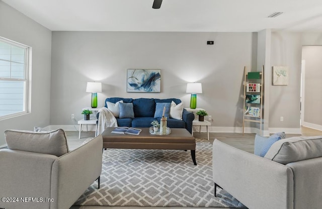 living room with ceiling fan and light wood-type flooring