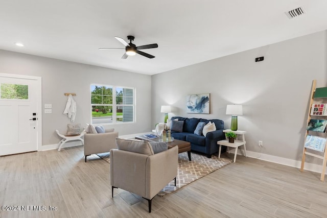 living room with ceiling fan and light wood-type flooring