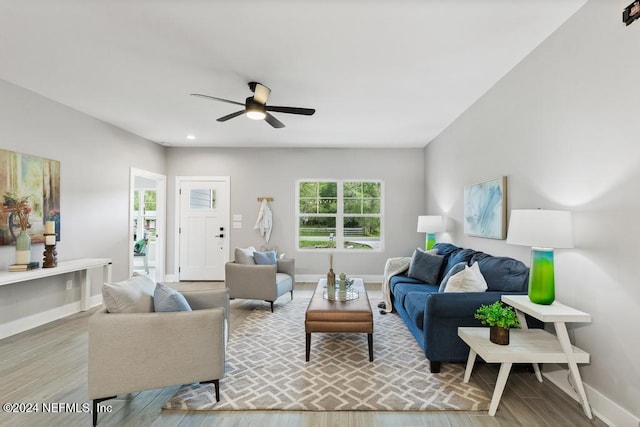 living room with wood-type flooring and ceiling fan