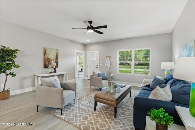 living room with ceiling fan and light wood-type flooring