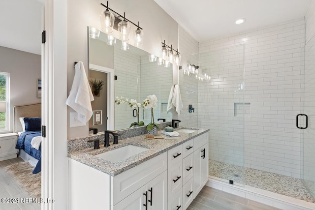 bathroom featuring vanity and an enclosed shower