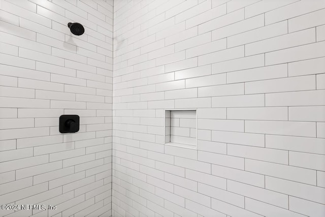 bathroom with tiled shower