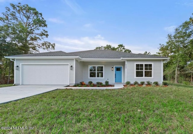 single story home with a garage and a front lawn