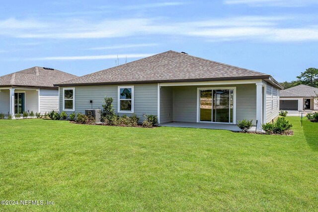 37148 Whippoorwill Ct, Hilliard, FL 32046 - rear view of house featuring central air condition unit, roof with shingles, a yard, and a patio
