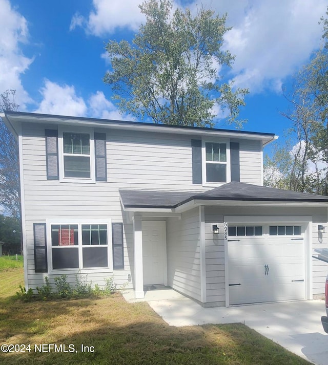 view of front of home with a garage and a front yard