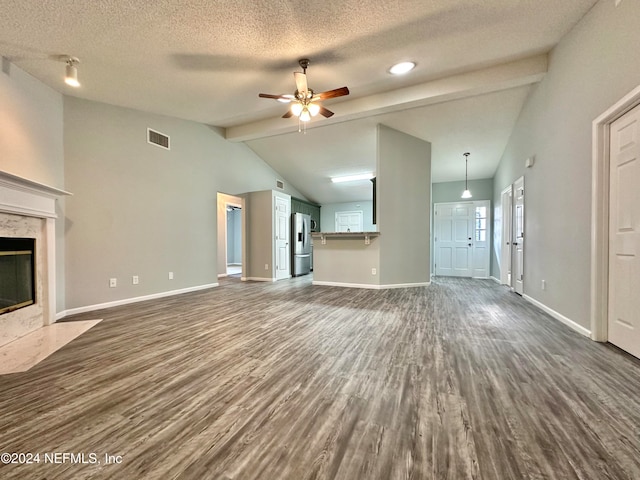 unfurnished living room featuring lofted ceiling with beams, ceiling fan, dark hardwood / wood-style floors, and a fireplace