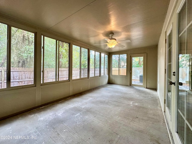 unfurnished sunroom with ceiling fan