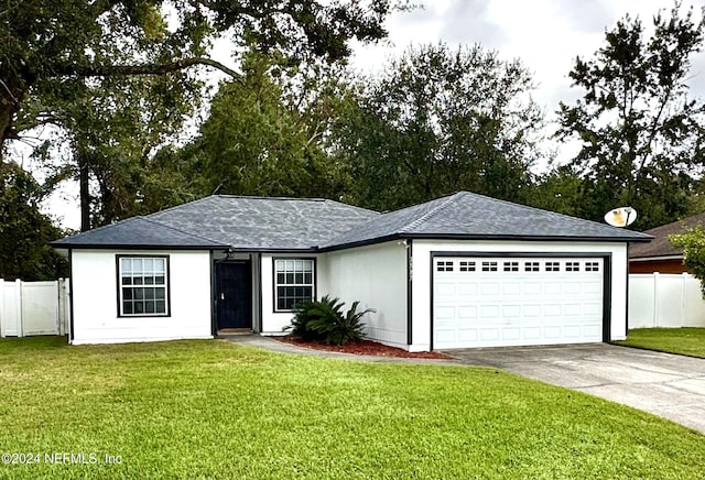 ranch-style home featuring a garage and a front lawn