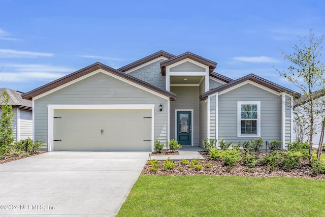 view of front of house with a garage and a front yard